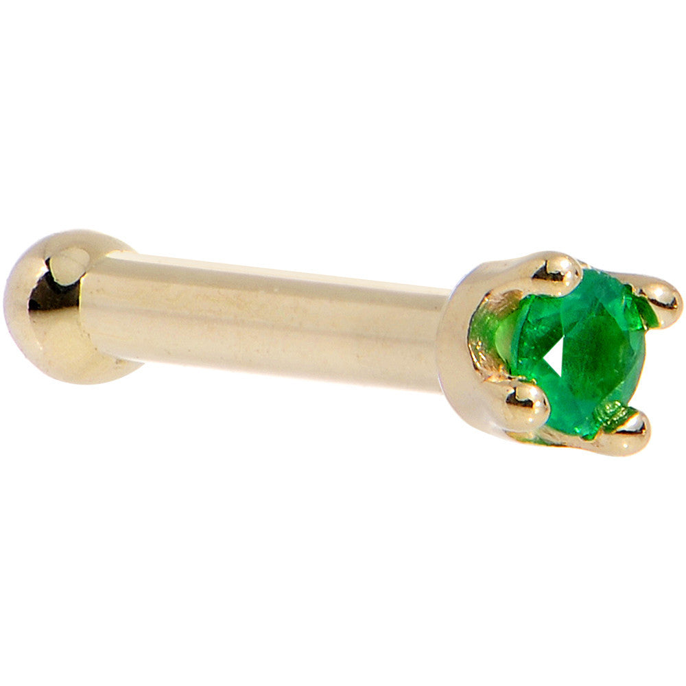 Gold barbell with a green gemstone on a white background