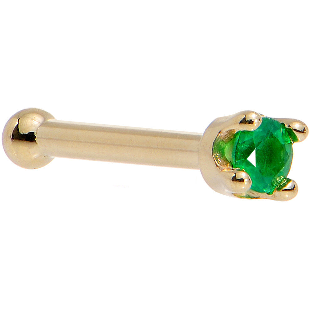Gold barbell with a green gemstone on a white background